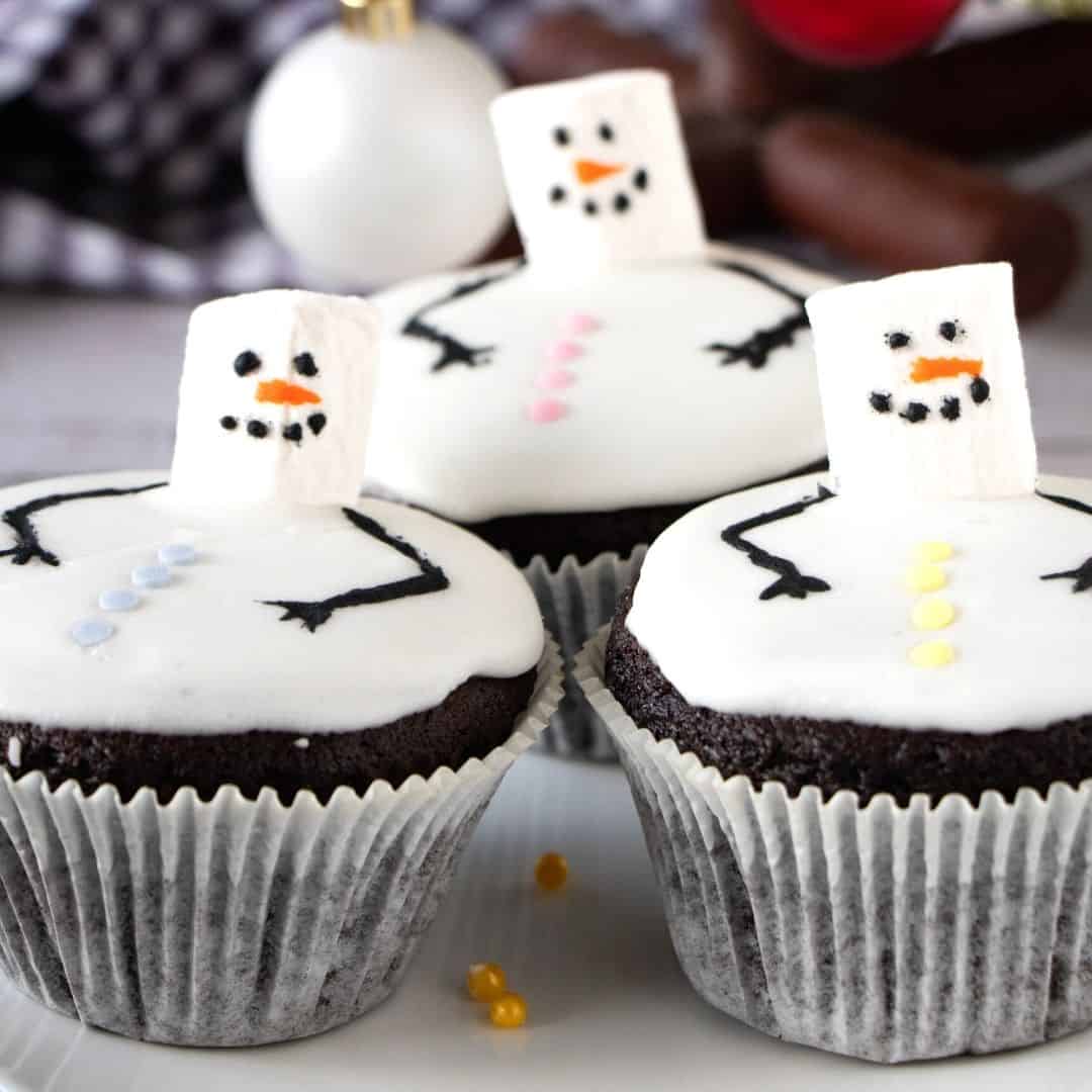 Melted Snowman Cupcakes, an adorable Christmas holiday season frosted cupcake with a decorated melted snowman on top.