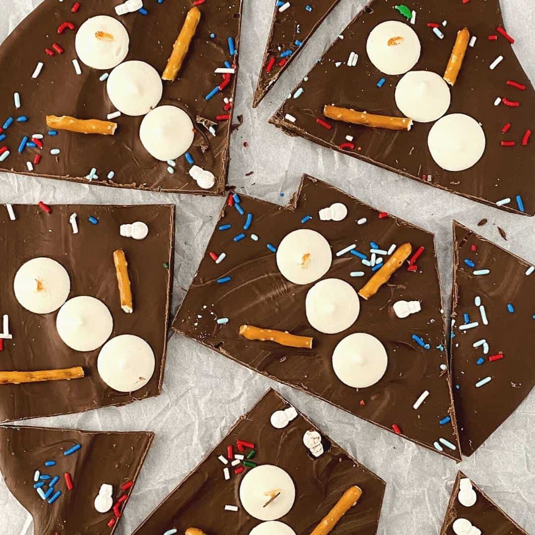 Chocolate Snowman Bark, an easy dessert or snack treat recipe with candy snowmen on a tasty chocolate base.
