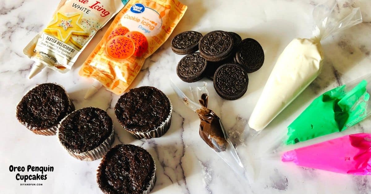 Oreo Penguin Cupcakes , a tasty and adorable baked chocolate cake dessert recipe that is topped with a decorated sandwich cookie.
