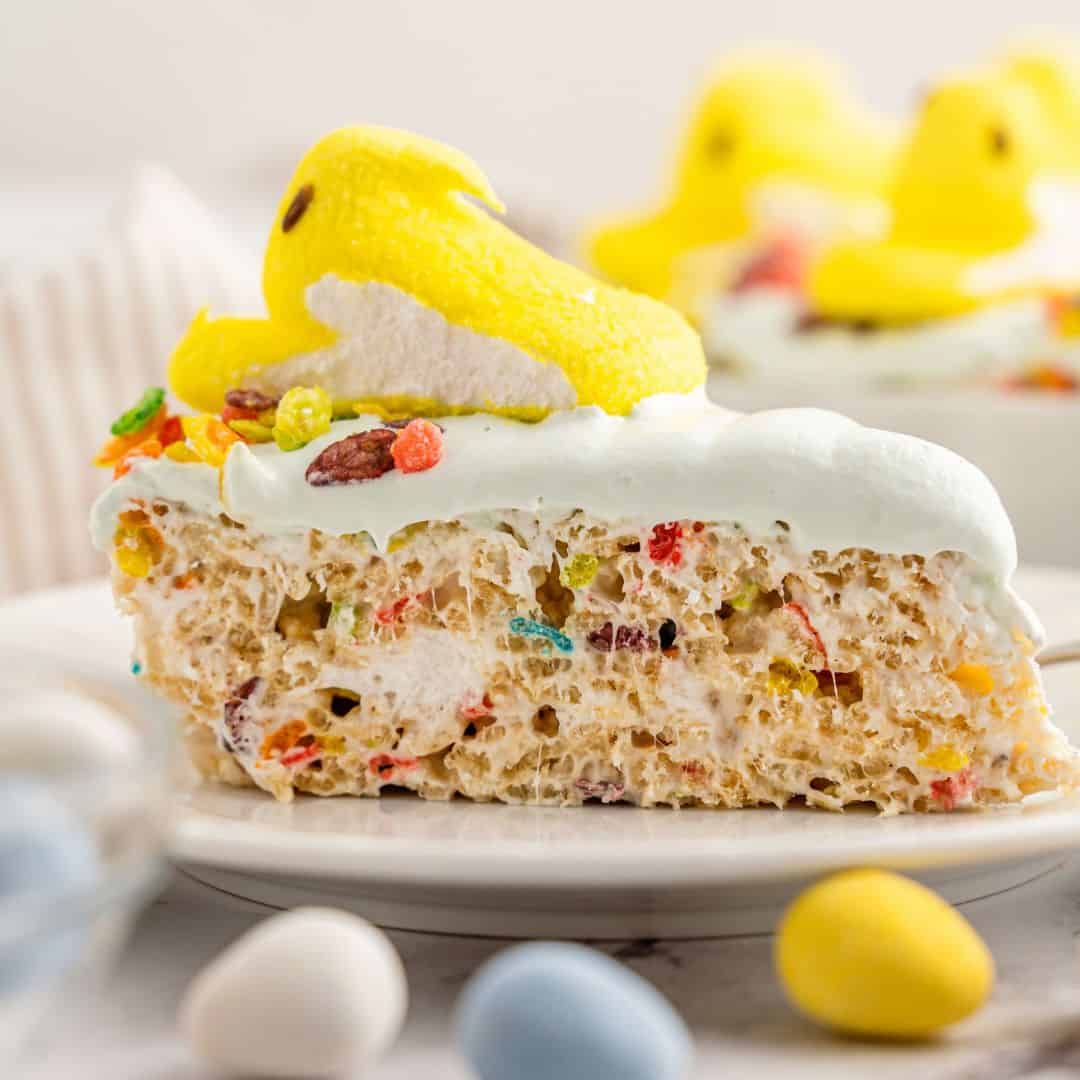 Peeps Rice Krispie Treats Cake, a delicious frosted cake recipe made with rice cereal and marshmallows, topped with an Easter Peep Candy.