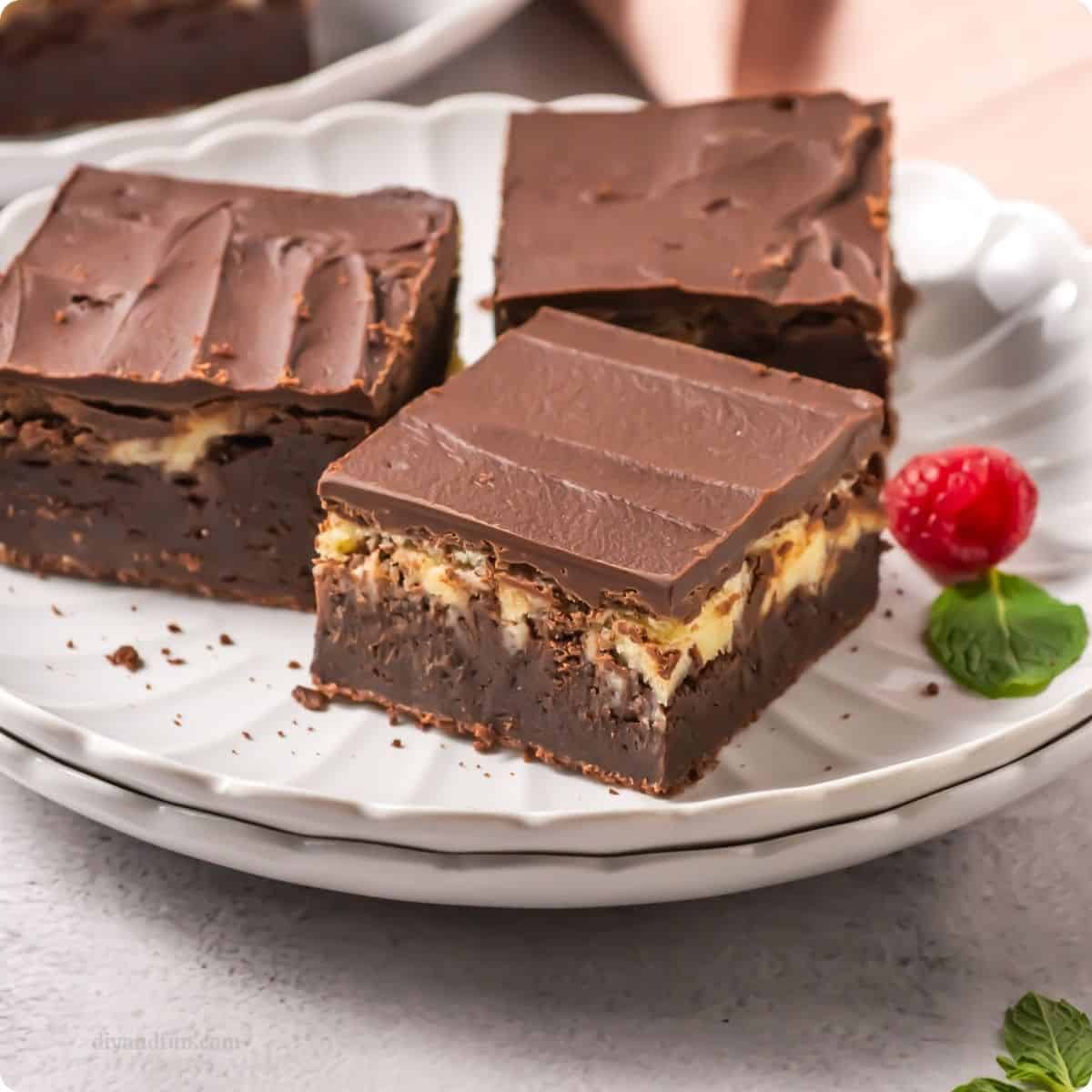 Perfectly Fudgy Homemade Cheesecake Brownies, a decadent, triple-layer dessert featuring a cheesecake center topped with chocolate ganache. Perfectly Fudgy Homemade Cheesecake Brownies, a decadent, triple-layer dessert featuring a cheesecake center topped with chocolate ganache.